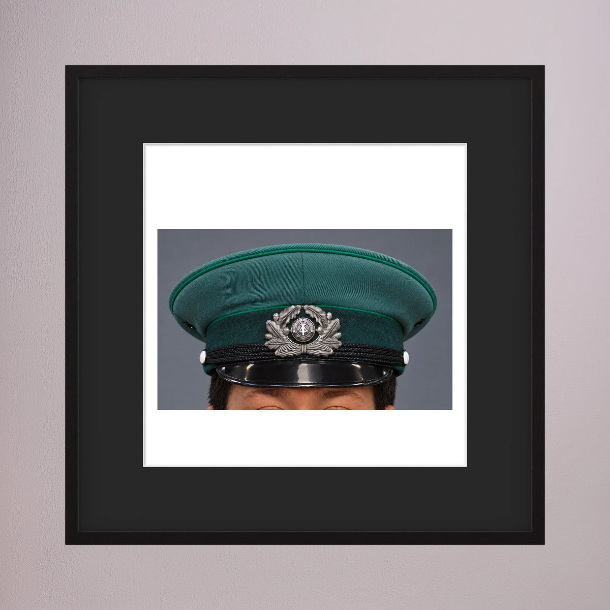 East German Volkpolizei (People's Police), Visor Cap, January 1989 — photograph displayed in a black wood frame mockup
