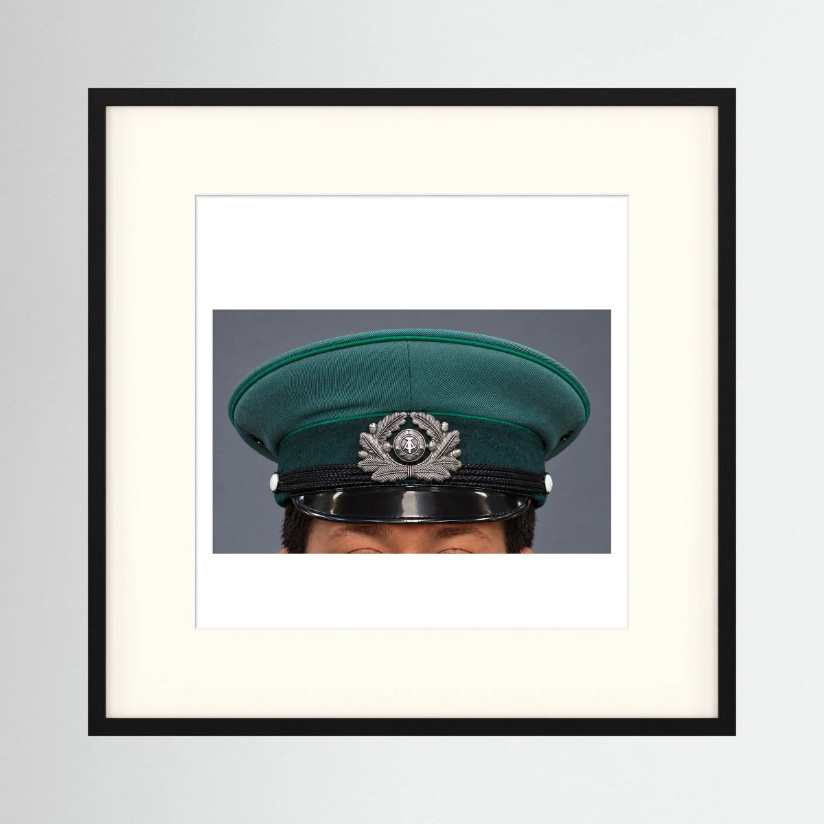 East German Volkpolizei (People's Police), Visor Cap, January 1989 — photograph displayed in a black wood frame mockup