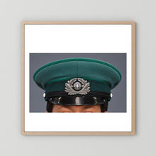 East German Volkpolizei (People's Police), Visor Cap, January 1989 — photograph displayed in a natural oak frame mockup