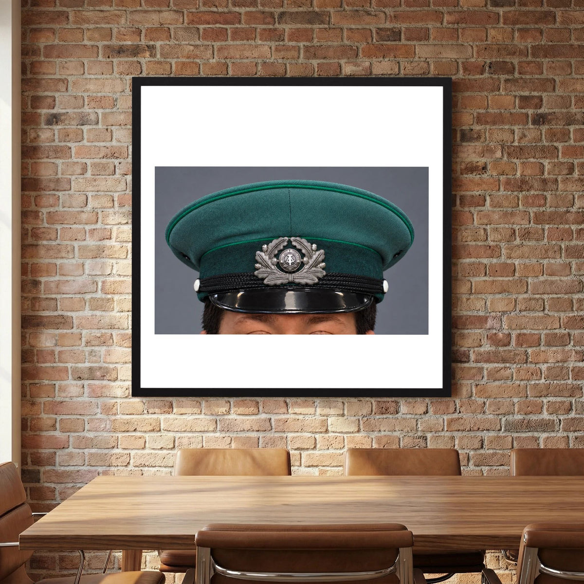 East German Volkpolizei (People's Police), Visor Cap, January 1989 — photograph displayed in a white wood frame mockup