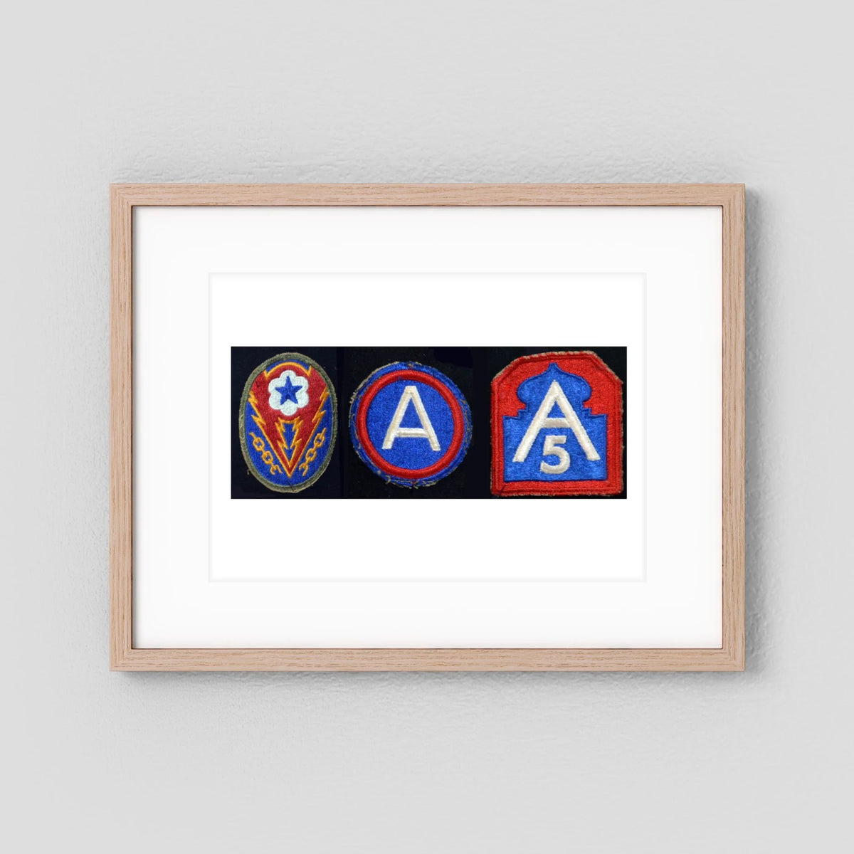 Shoulder Sleeve Insignia, US Army WW2 — composite displayed in a black wood frame mockup