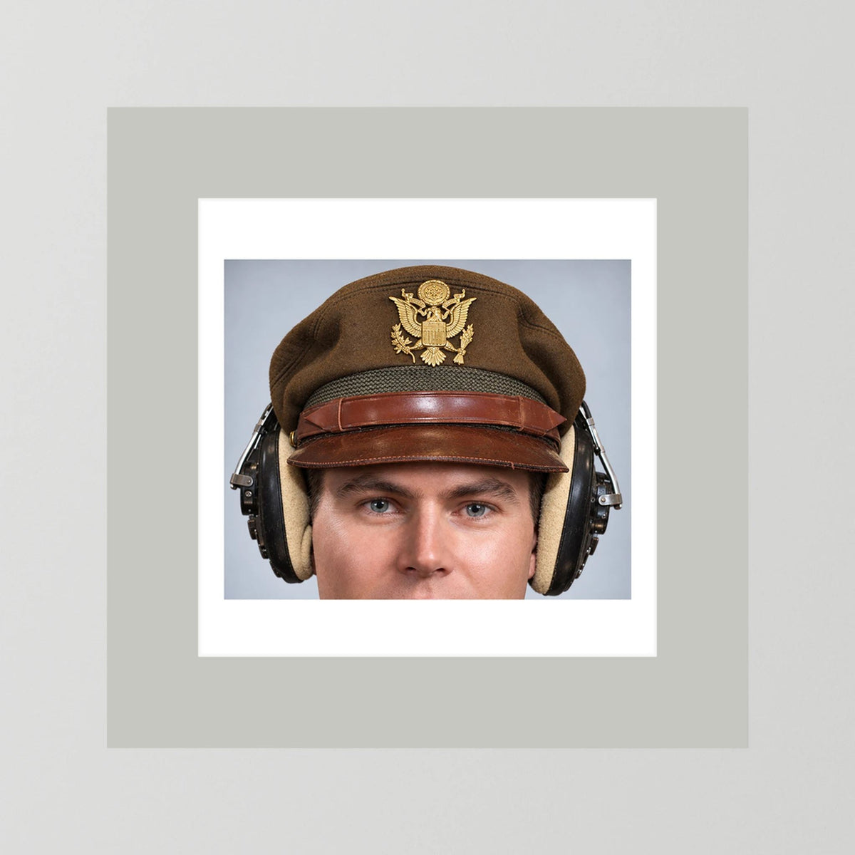 US Army Air Force WW2 Crusher Caps with headphones. Temperate Cover — photograph displayed in a black wood frame mockup