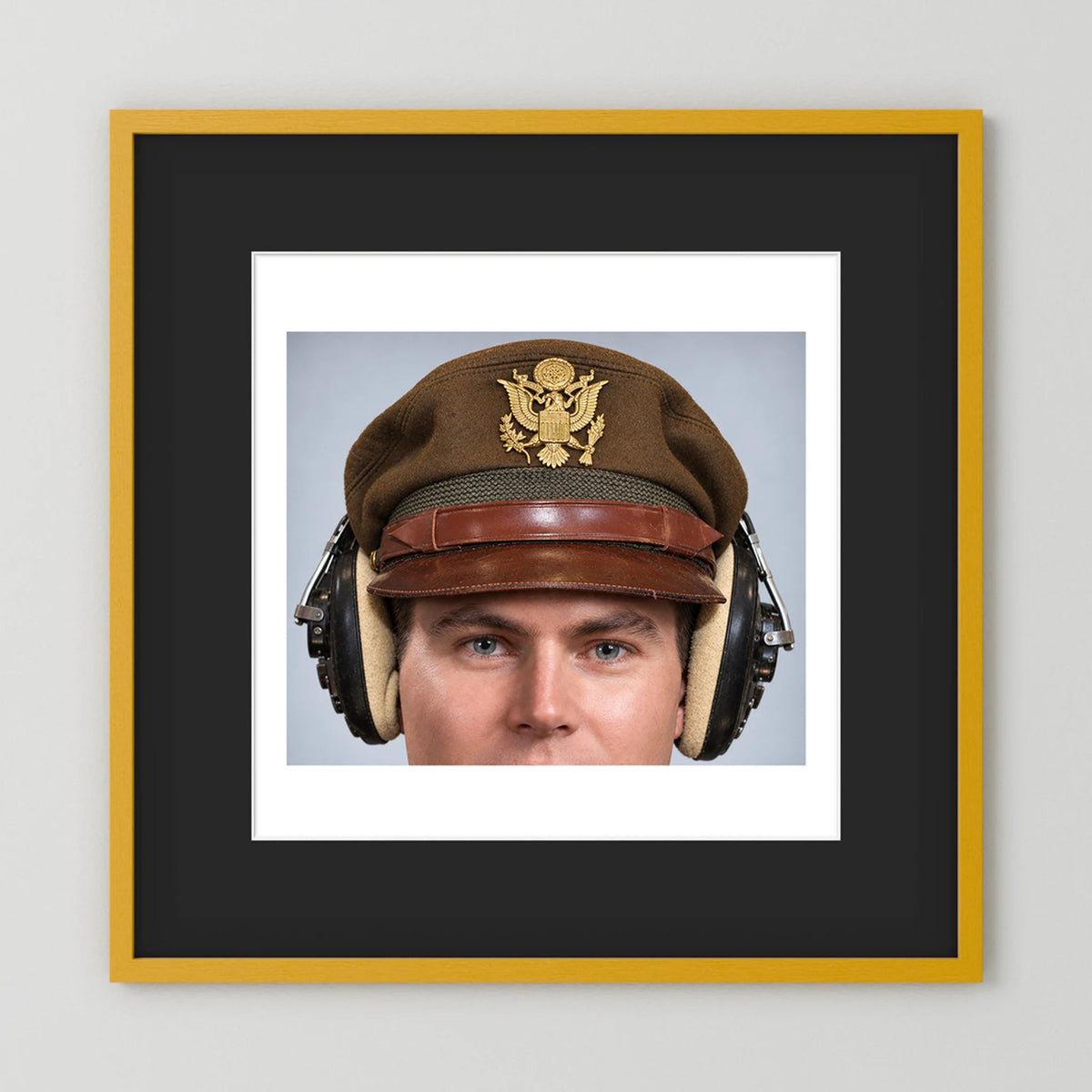 US Army Air Force WW2 Crusher Caps with headphones. Temperate Cover — photograph displayed in a black wood frame mockup