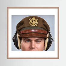 US Army Air Force WW2 Crusher Caps with headphones. Temperate Cover — photograph displayed in a black wood frame mockup
