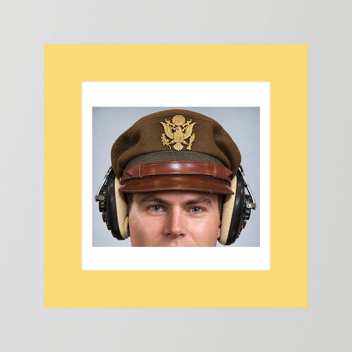 US Army Air Force WW2 Crusher Caps with headphones. Temperate Cover — photograph displayed in a black wood frame mockup