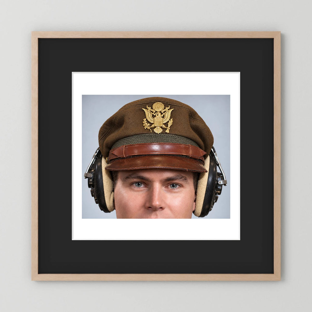 US Army Air Force WW2 Crusher Caps with headphones. Temperate Cover — photograph displayed in a black wood frame mockup