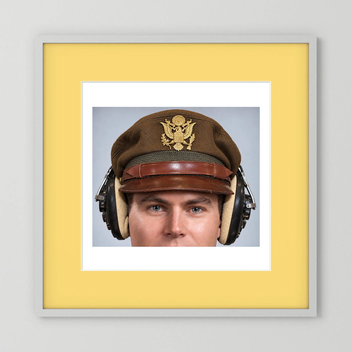 US Army Air Force WW2 Crusher Caps with headphones. Temperate Cover — photograph displayed in a black wood frame mockup