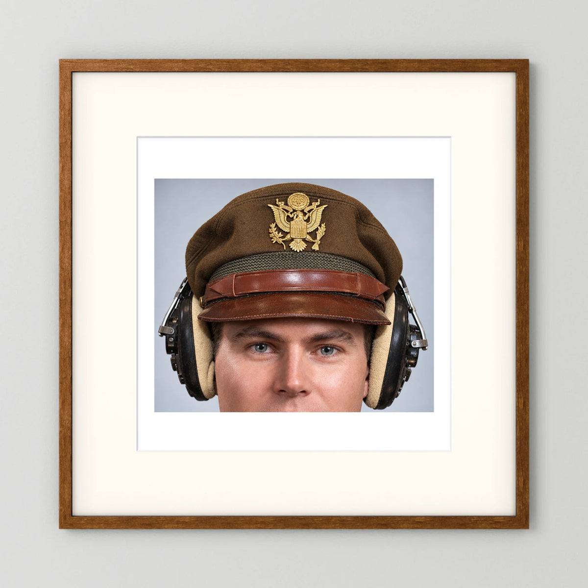 US Army Air Force WW2 Crusher Caps with headphones. Temperate Cover — photograph displayed in a black wood frame mockup
