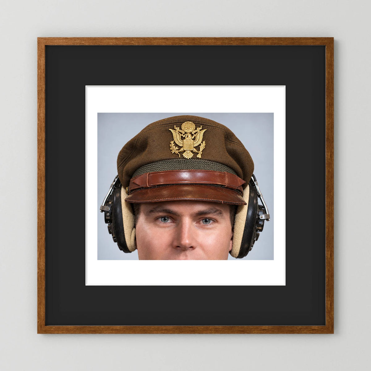 US Army Air Force WW2 Crusher Caps with headphones. Temperate Cover — photograph displayed in a black wood frame mockup