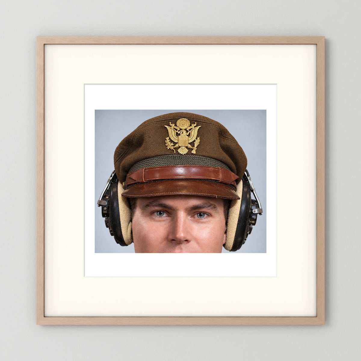US Army Air Force WW2 Crusher Caps with headphones. Temperate Cover — photograph displayed in a black wood frame mockup