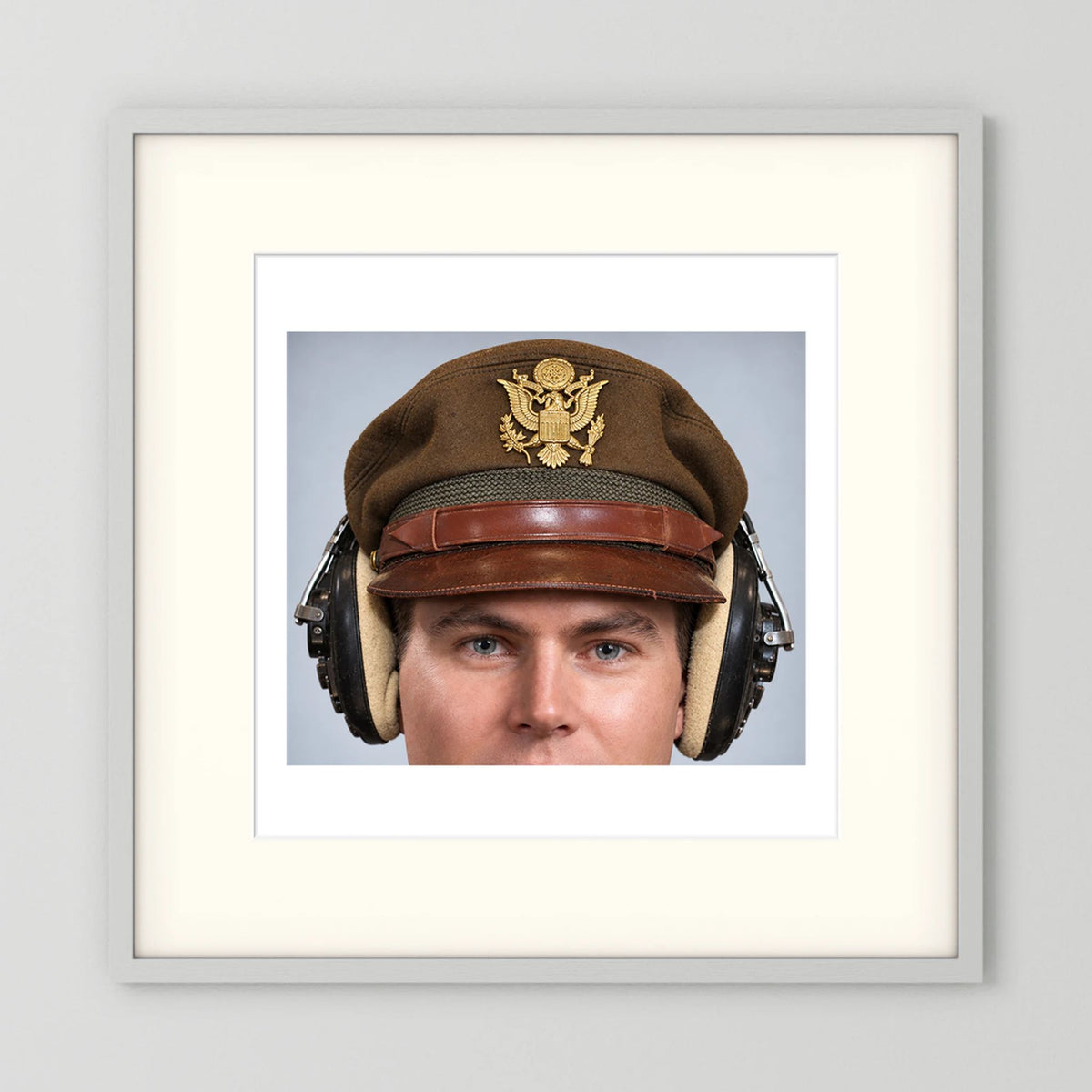 US Army Air Force WW2 Crusher Caps with headphones. Temperate Cover — photograph displayed in a black wood frame mockup