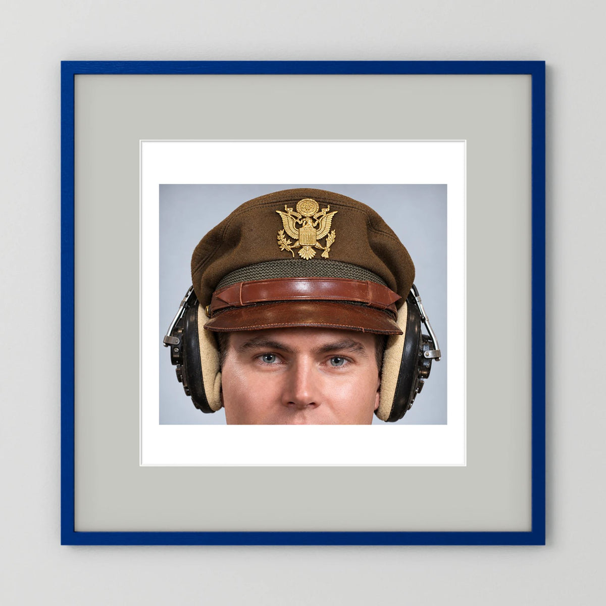 US Army Air Force WW2 Crusher Caps with headphones. Temperate Cover — photograph displayed in a black wood frame mockup