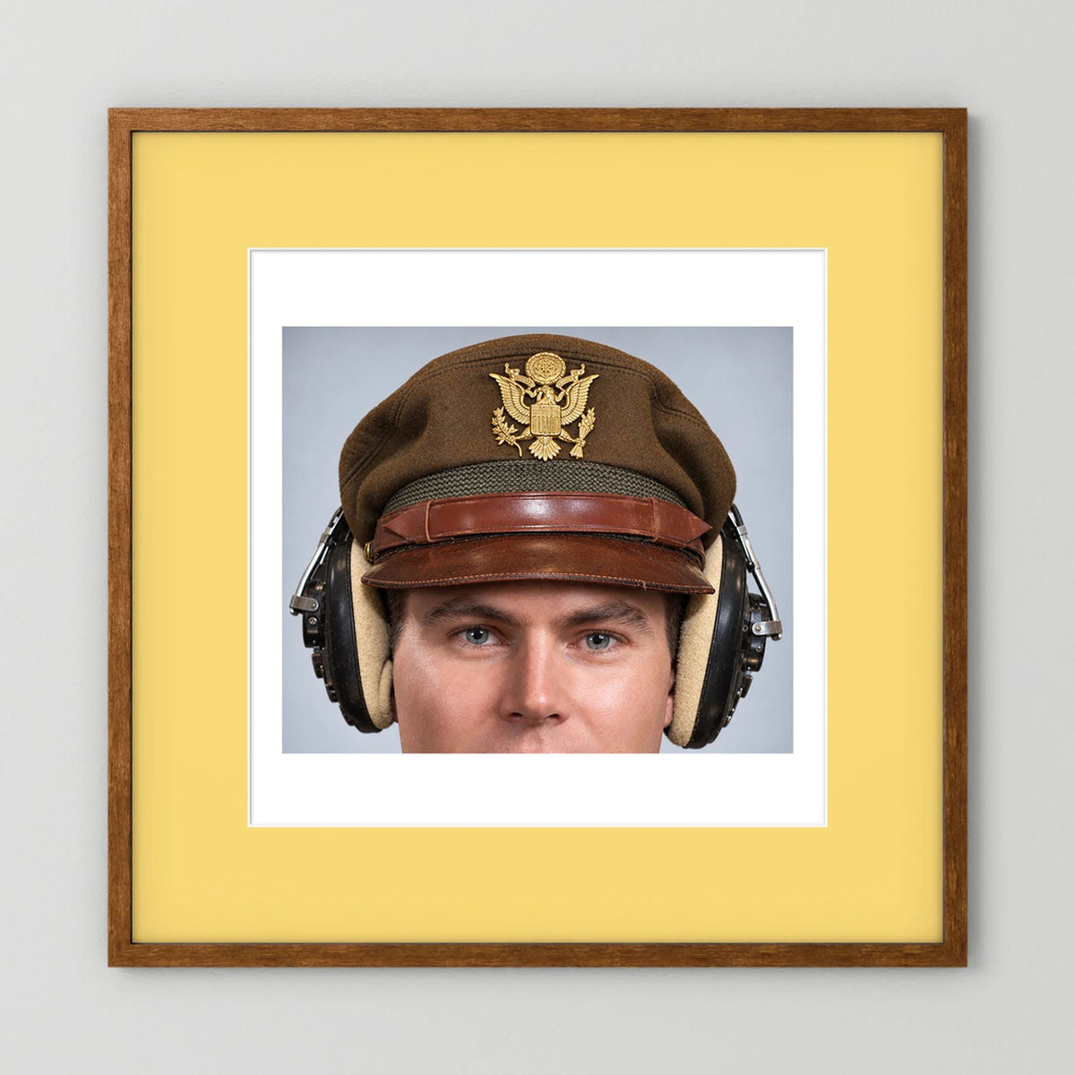US Army Air Force WW2 Crusher Caps with headphones. Temperate Cover — photograph displayed in a black wood frame mockup