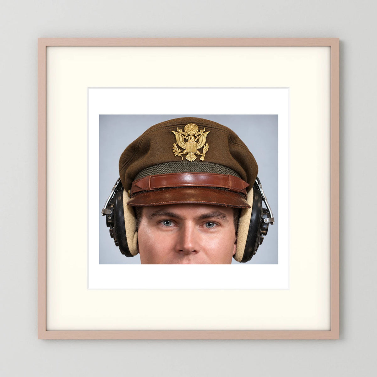 US Army Air Force WW2 Crusher Caps with headphones. Temperate Cover — photograph displayed in a black wood frame mockup