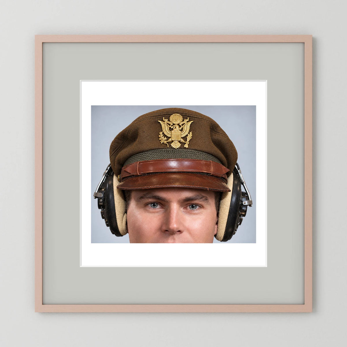US Army Air Force WW2 Crusher Caps with headphones. Temperate Cover — photograph displayed in a black wood frame mockup