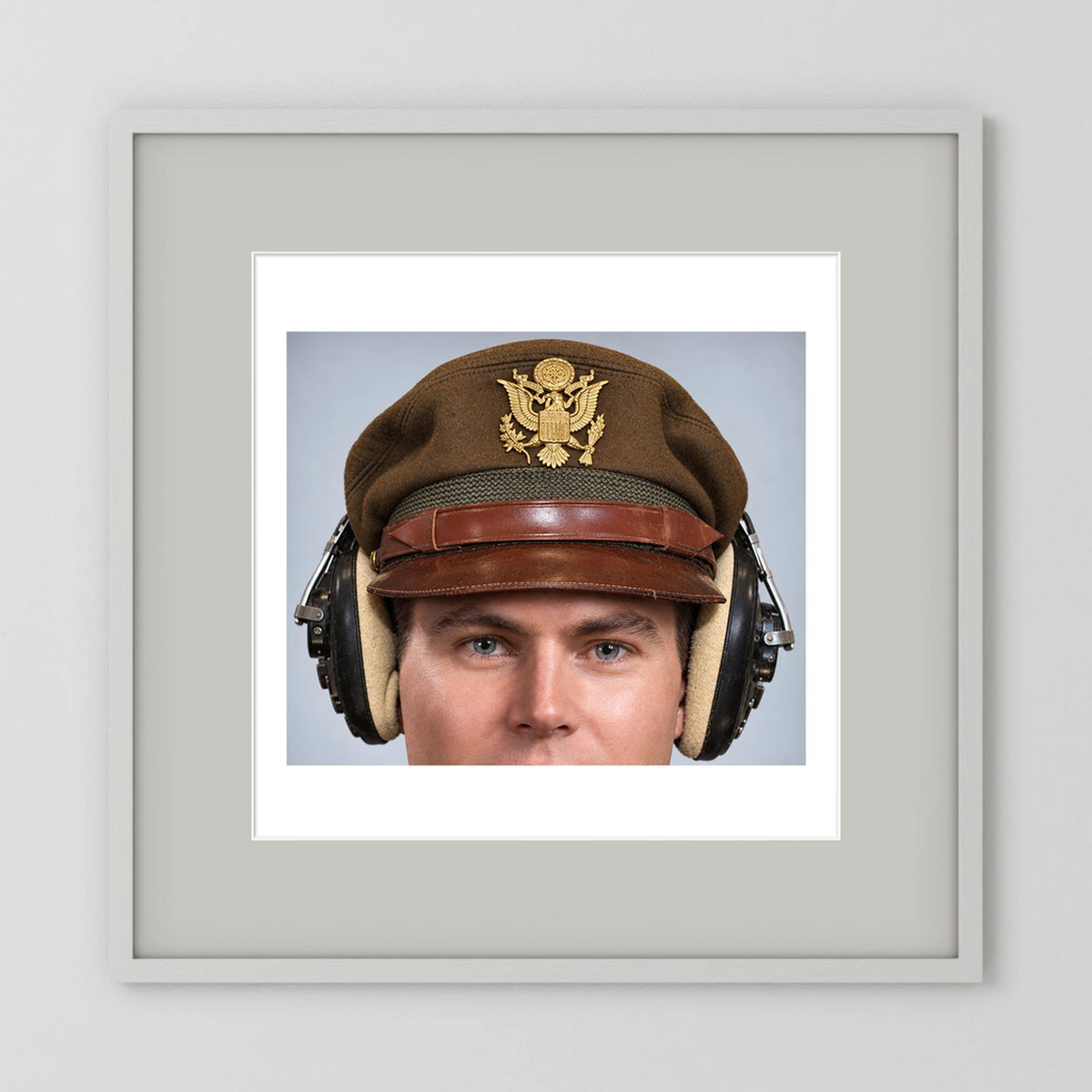 US Army Air Force WW2 Crusher Caps with headphones. Temperate Cover — photograph displayed in a black wood frame mockup