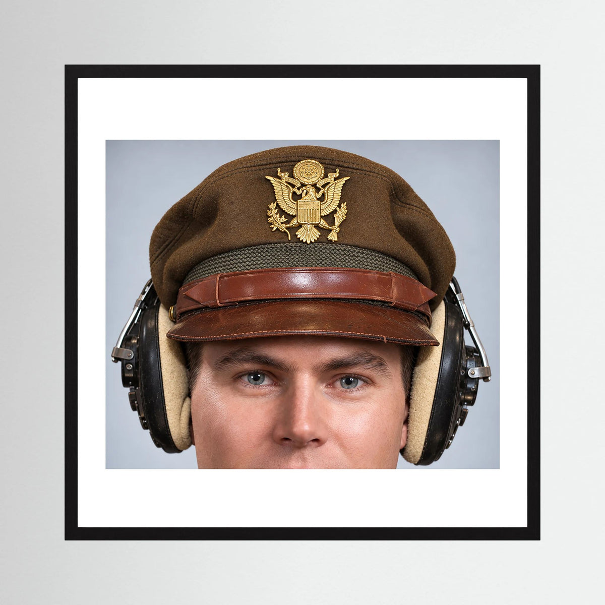US Army Air Force WW2 Crusher Caps with headphones. Temperate Cover — photograph displayed in a black wood frame mockup