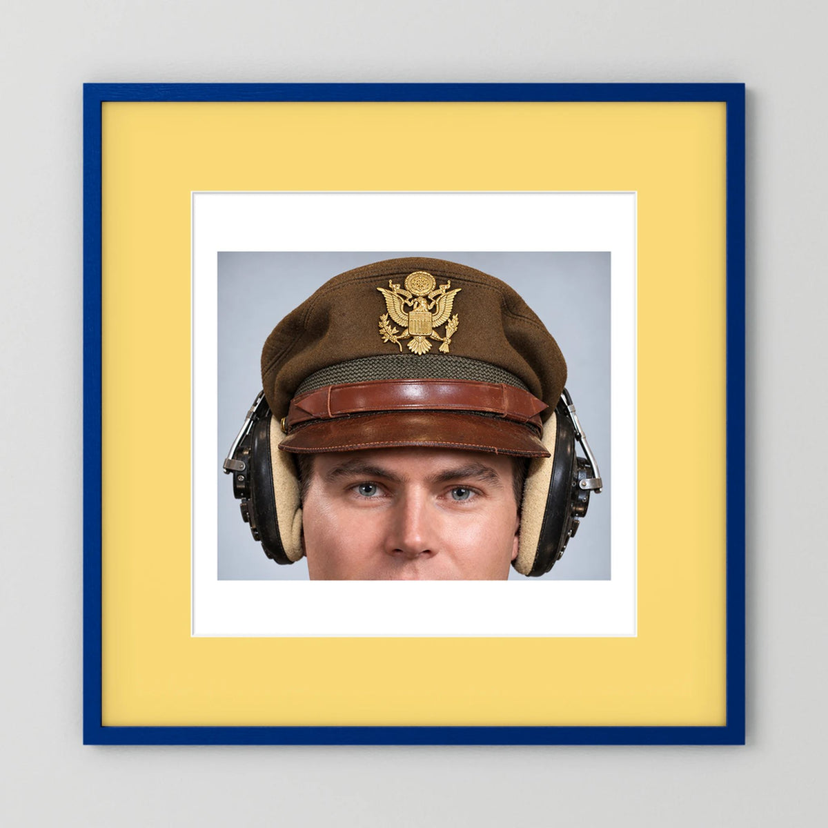 US Army Air Force WW2 Crusher Caps with headphones. Temperate Cover — photograph displayed in a black wood frame mockup