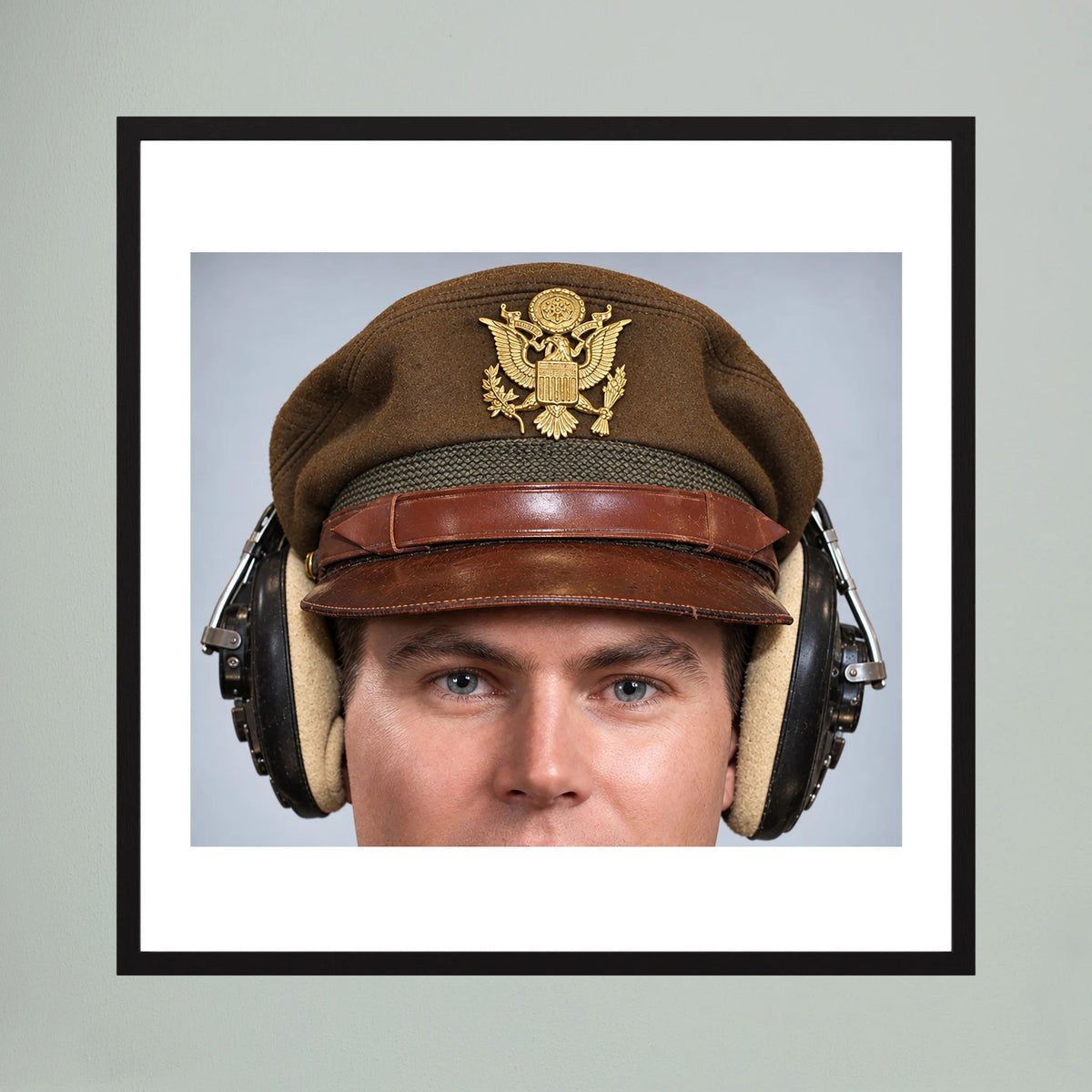 US Army Air Force WW2 Crusher Caps with headphones. Temperate Cover — photograph displayed in a black wood frame mockup
