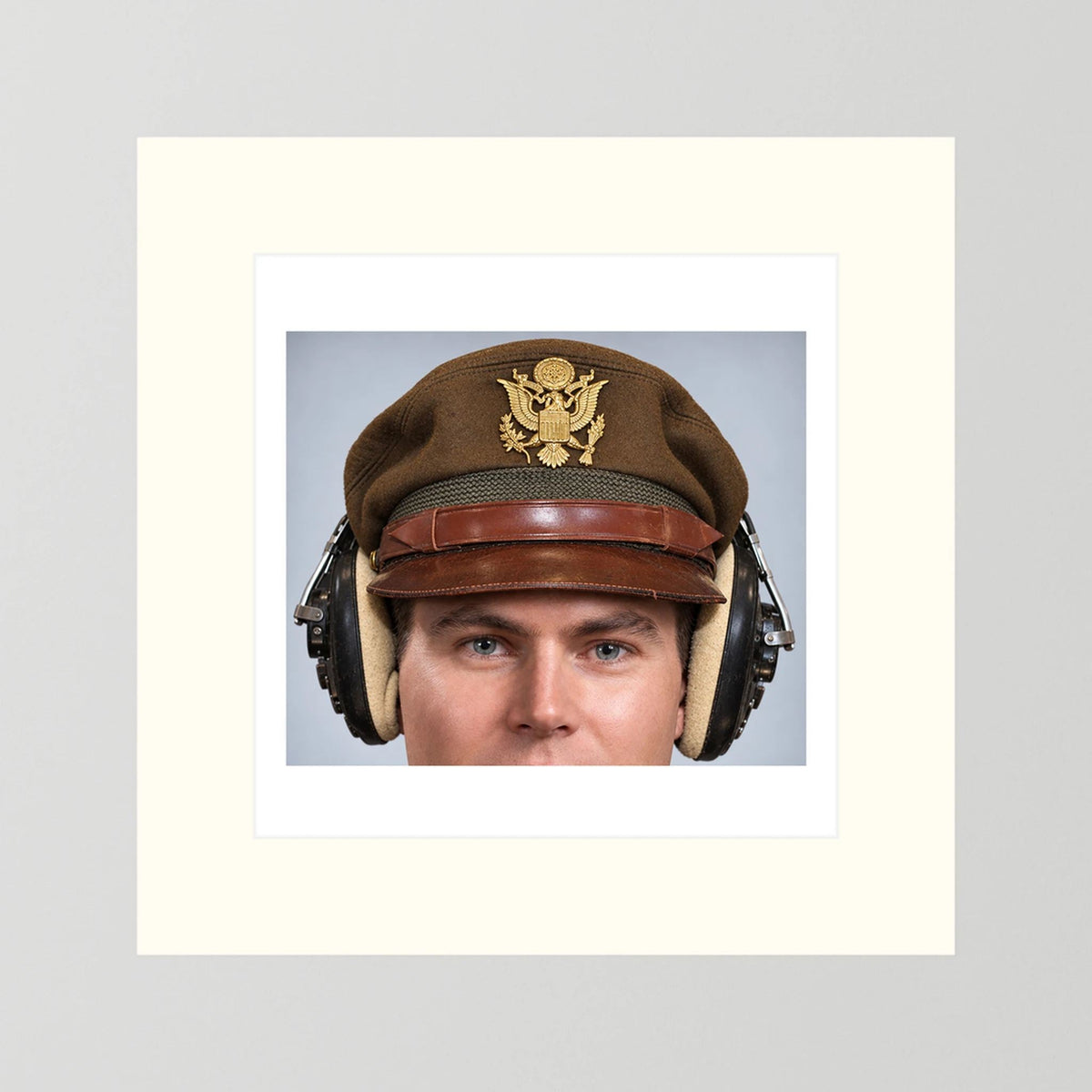 US Army Air Force WW2 Crusher Caps with headphones. Temperate Cover — photograph displayed in a black wood frame mockup