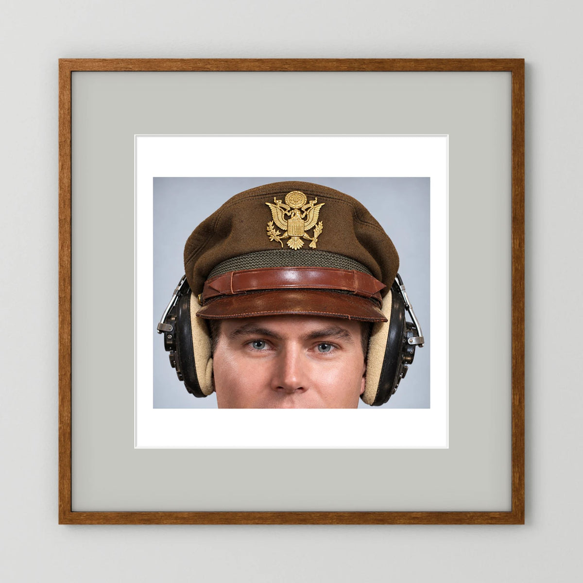 US Army Air Force WW2 Crusher Caps with headphones. Temperate Cover — photograph displayed in a black wood frame mockup