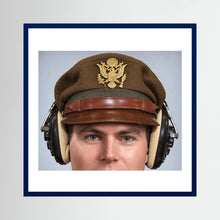 US Army Air Force WW2 Crusher Caps with headphones. Temperate Cover — photograph displayed in a black wood frame mockup