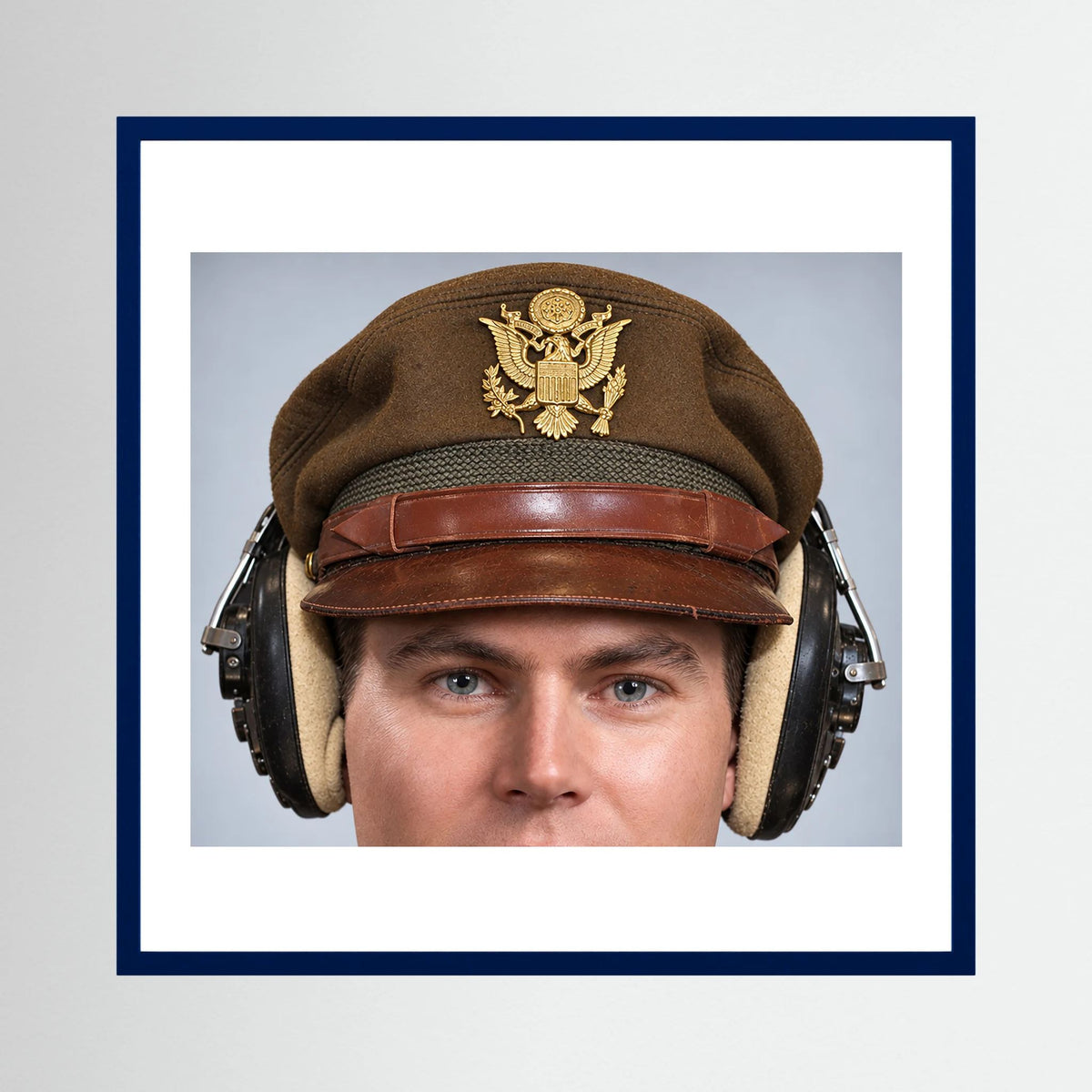 US Army Air Force WW2 Crusher Caps with headphones. Temperate Cover — photograph displayed in a black wood frame mockup