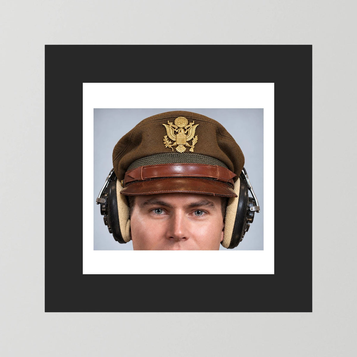US Army Air Force WW2 Crusher Caps with headphones. Temperate Cover — photograph displayed in a black wood frame mockup