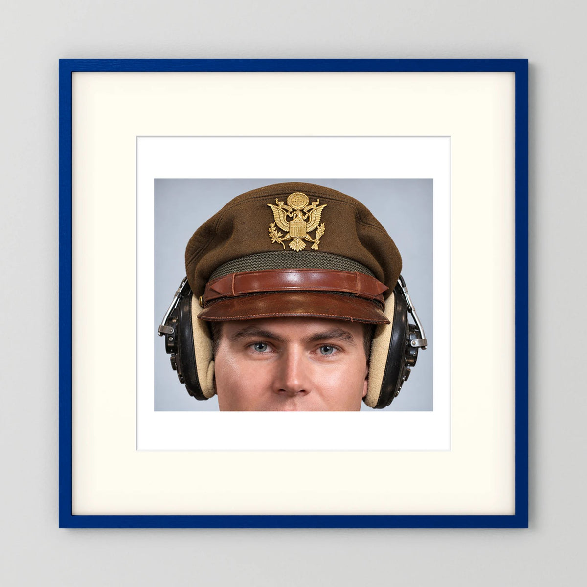 US Army Air Force WW2 Crusher Caps with headphones. Temperate Cover — photograph displayed in a black wood frame mockup