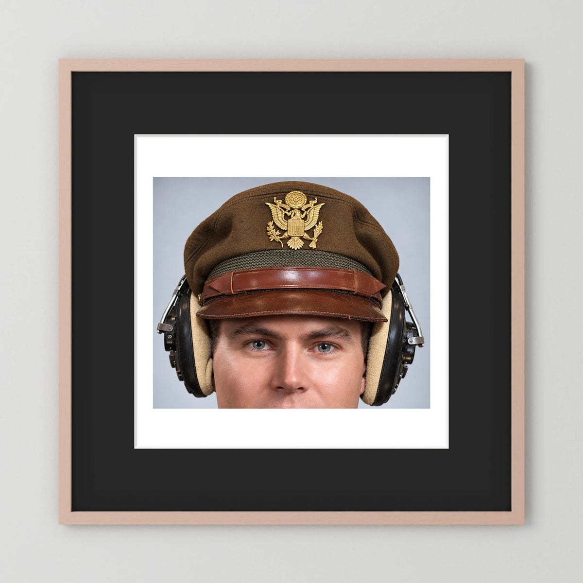 US Army Air Force WW2 Crusher Caps with headphones. Temperate Cover — photograph displayed in a black wood frame mockup