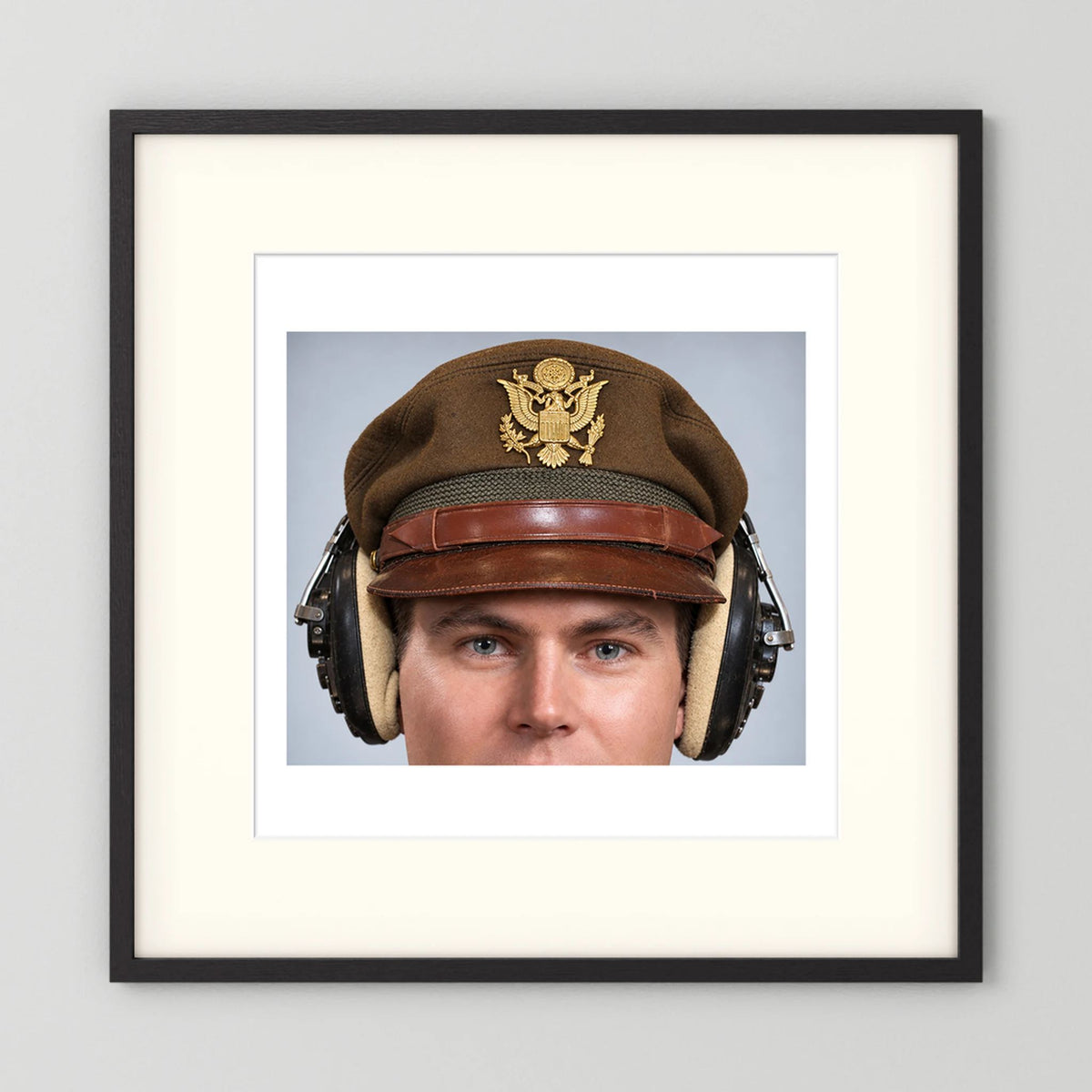 US Army Air Force WW2 Crusher Caps with headphones. Temperate Cover — photograph displayed in a black wood frame mockup
