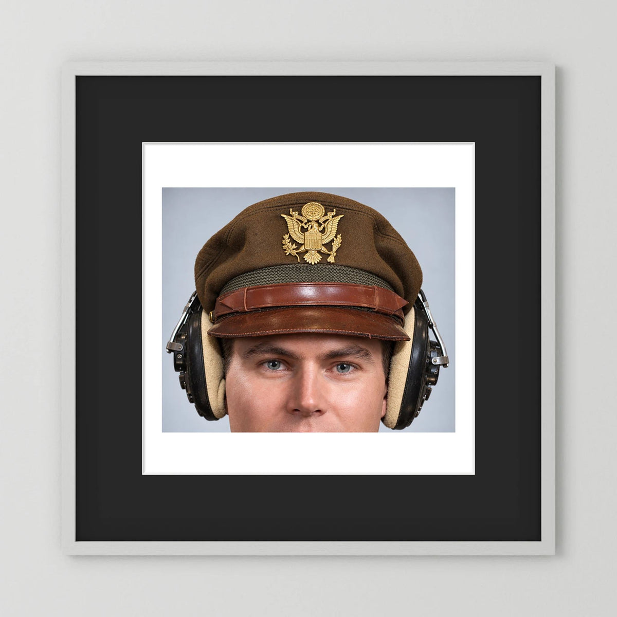 US Army Air Force WW2 Crusher Caps with headphones. Temperate Cover — photograph displayed in a black wood frame mockup