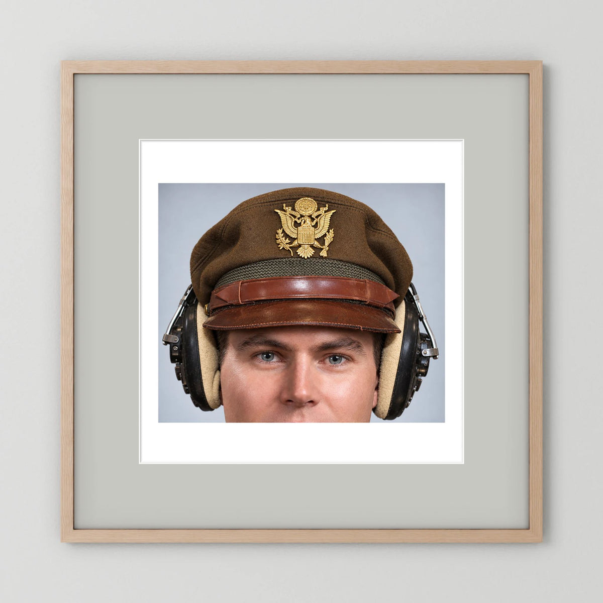 US Army Air Force WW2 Crusher Caps with headphones. Temperate Cover — photograph displayed in a black wood frame mockup