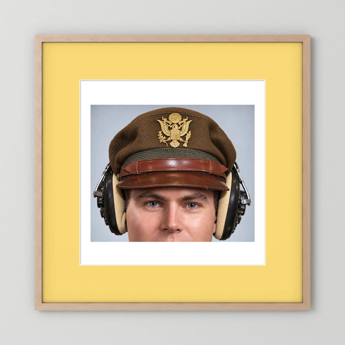 US Army Air Force WW2 Crusher Caps with headphones. Temperate Cover — photograph displayed in a black wood frame mockup