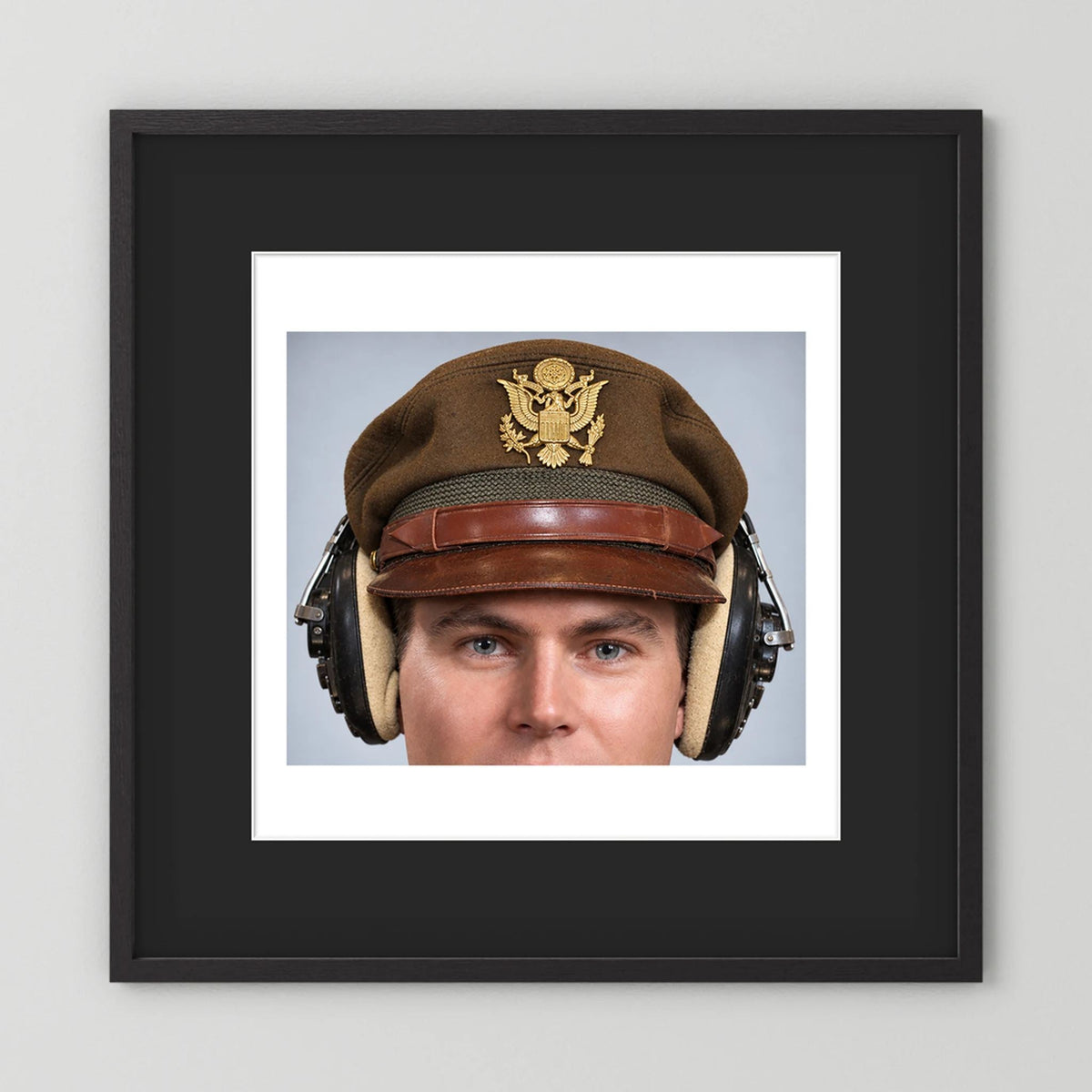 US Army Air Force WW2 Crusher Caps with headphones. Temperate Cover — photograph displayed in a black wood frame mockup