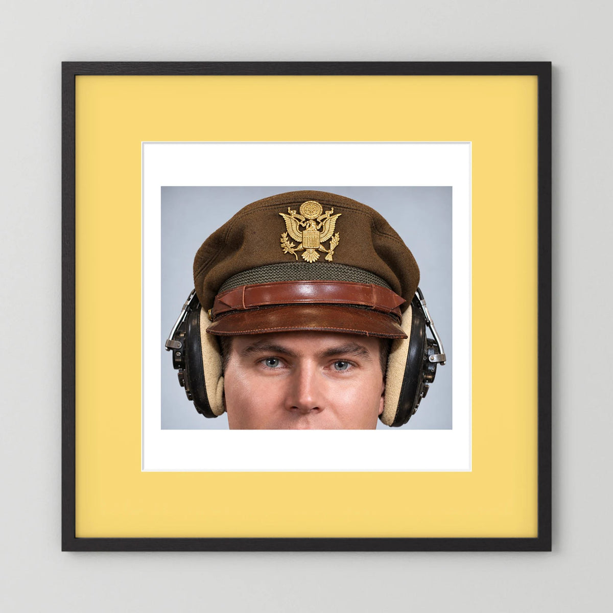 US Army Air Force WW2 Crusher Caps with headphones. Temperate Cover — photograph displayed in a black wood frame mockup