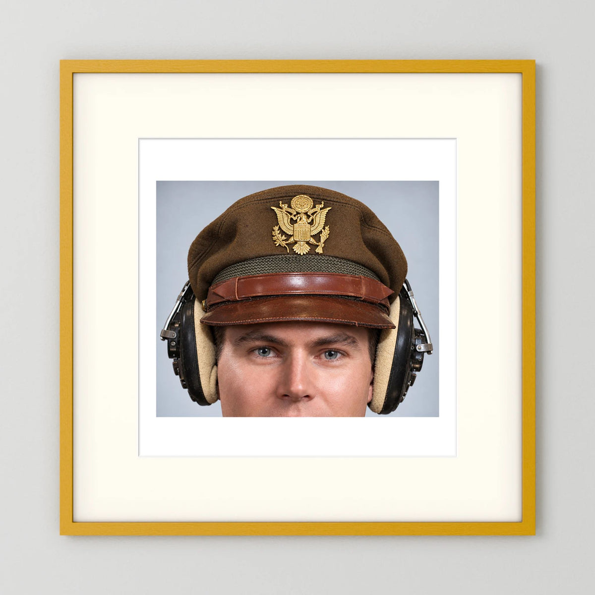 US Army Air Force WW2 Crusher Caps with headphones. Temperate Cover — photograph displayed in a black wood frame mockup