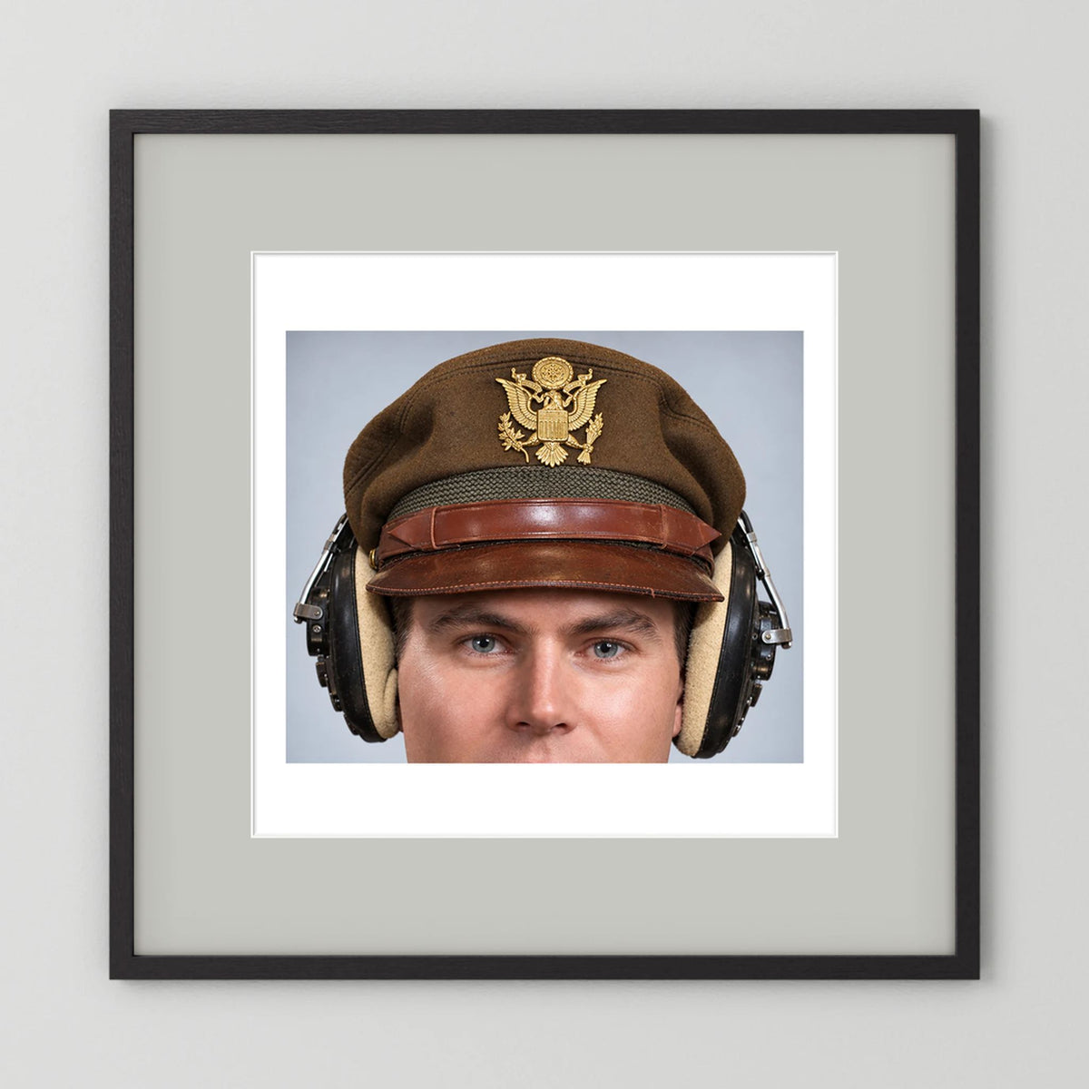US Army Air Force WW2 Crusher Caps with headphones. Temperate Cover — photograph displayed in a black wood frame mockup