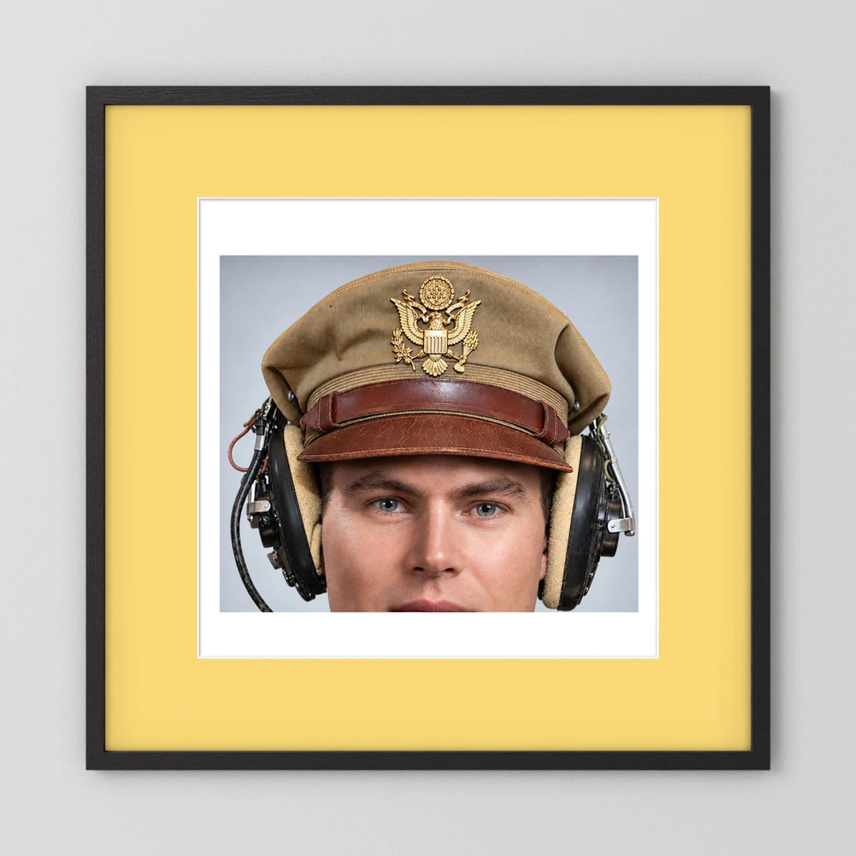 US Army Air Force WW2 Crusher Caps with headphones. Tropical Cover — photograph displayed in a black wood frame mockup