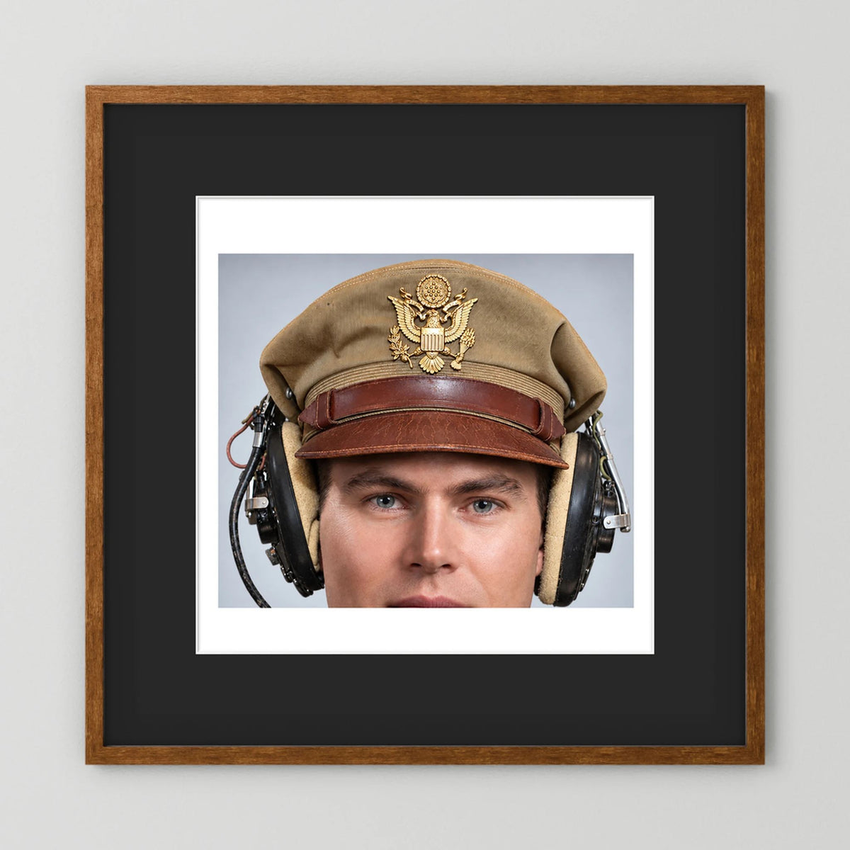 US Army Air Force WW2 Crusher Caps with headphones. Tropical Cover — photograph displayed in a black wood frame mockup