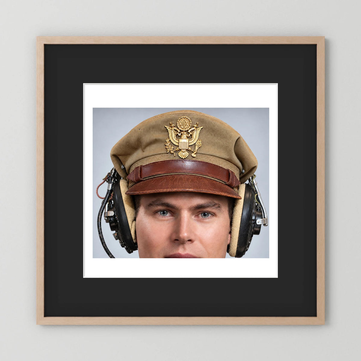 US Army Air Force WW2 Crusher Caps with headphones. Tropical Cover — photograph displayed in a black wood frame mockup